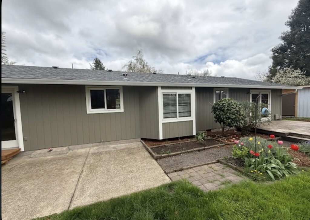 Siding installation in Eugene, Oregon featuring updated exterior siding, white trim, new windows, and a finished residential exterior.  