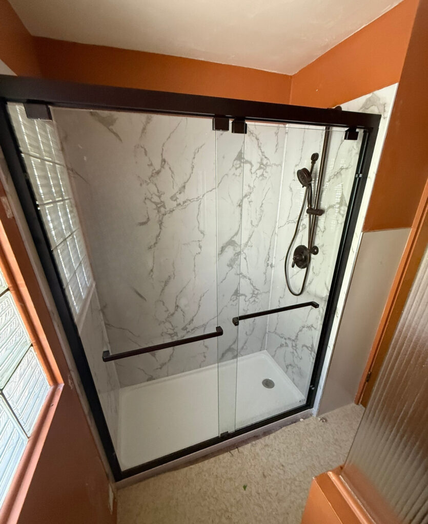 Tub to walk in shower conversion with glass door, black trim and polymarm finish in Springfield, Oregon. 