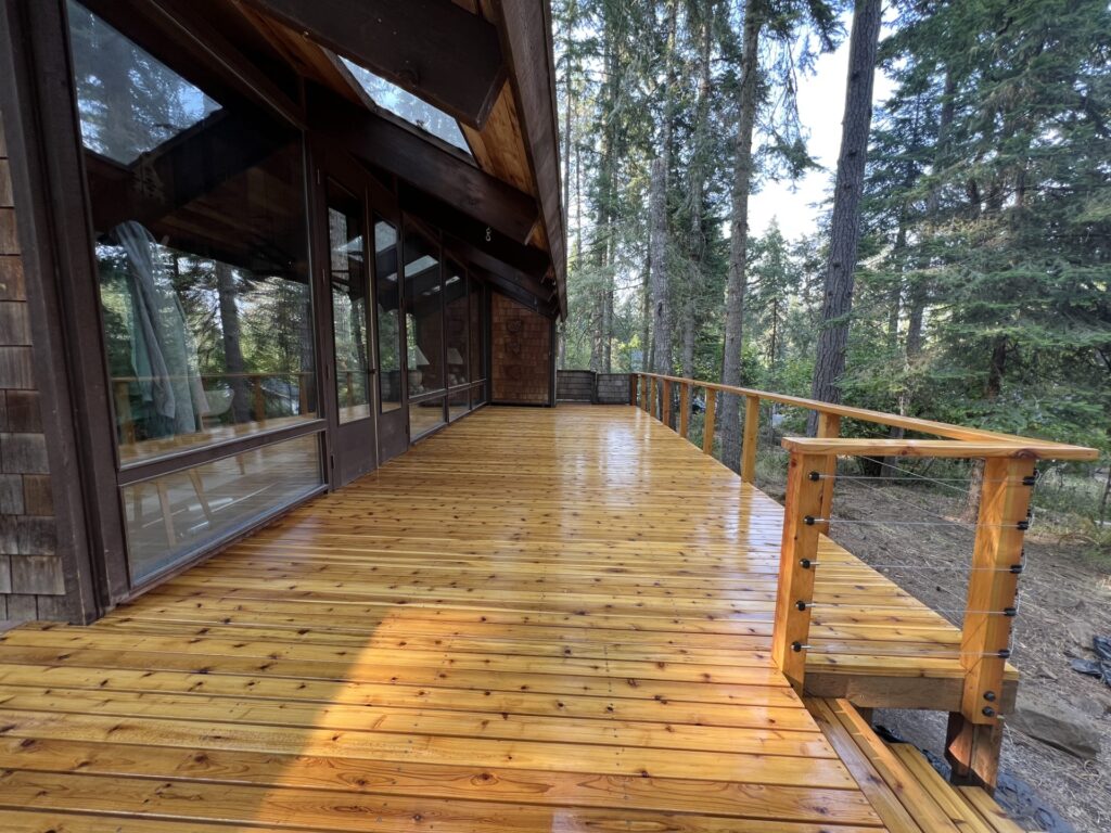Newly built wood deck with cable railing on a forested home in Eugene, Oregon.