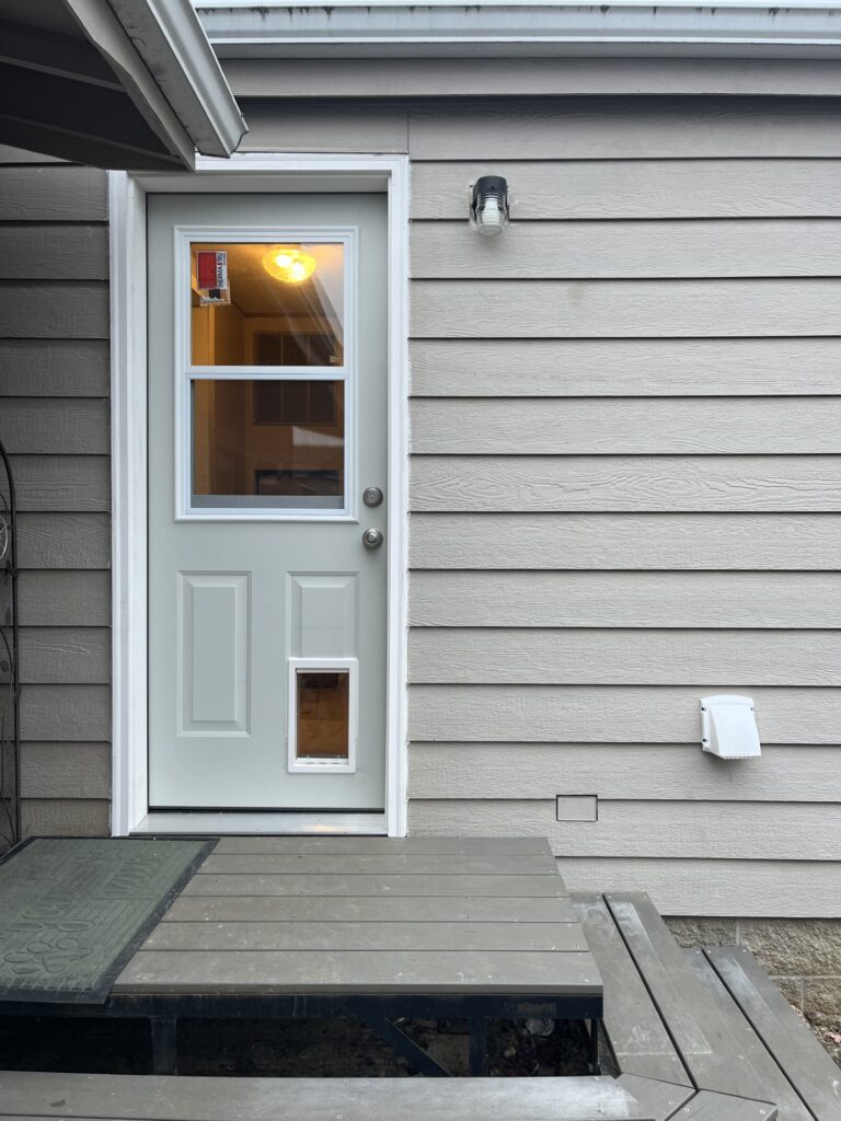Back door installation with dog door in Junction City, Oregon. 