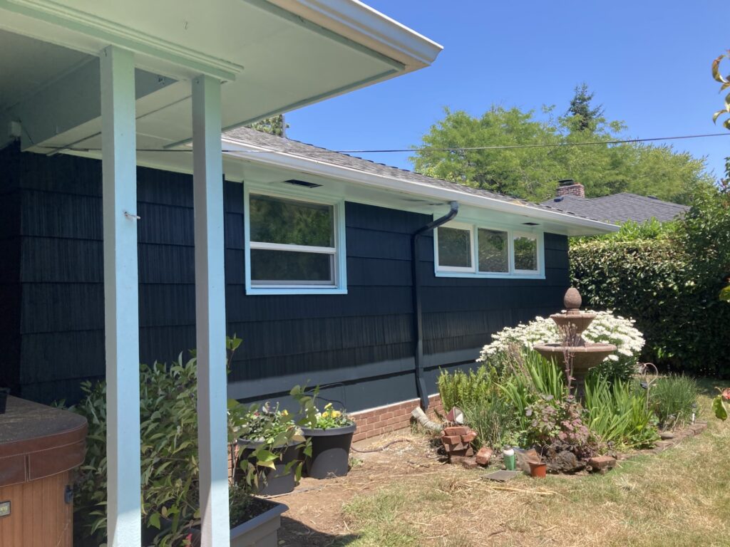 Siding installation with blue exterior and white trim paint in Veneta, OR