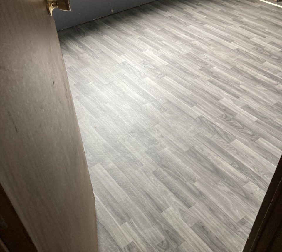 Grey wood look luxury vinyl plank install in Junction City, Oregon.