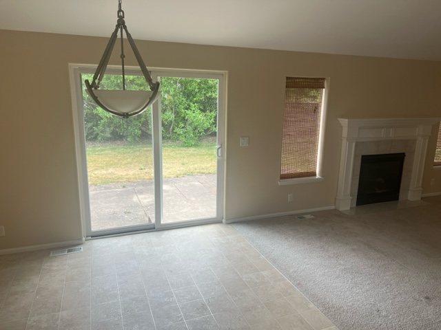 Interior painting in Junction City, Oregon featuring freshly painted walls, white trim, and a sliding glass door.