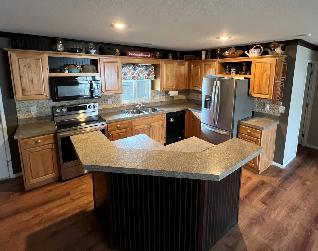 This kitchen remodel was updated with new cabinets, countertops, luxury vinyl plank flooring and stainless steel appliances in Creswell, Oregon. 