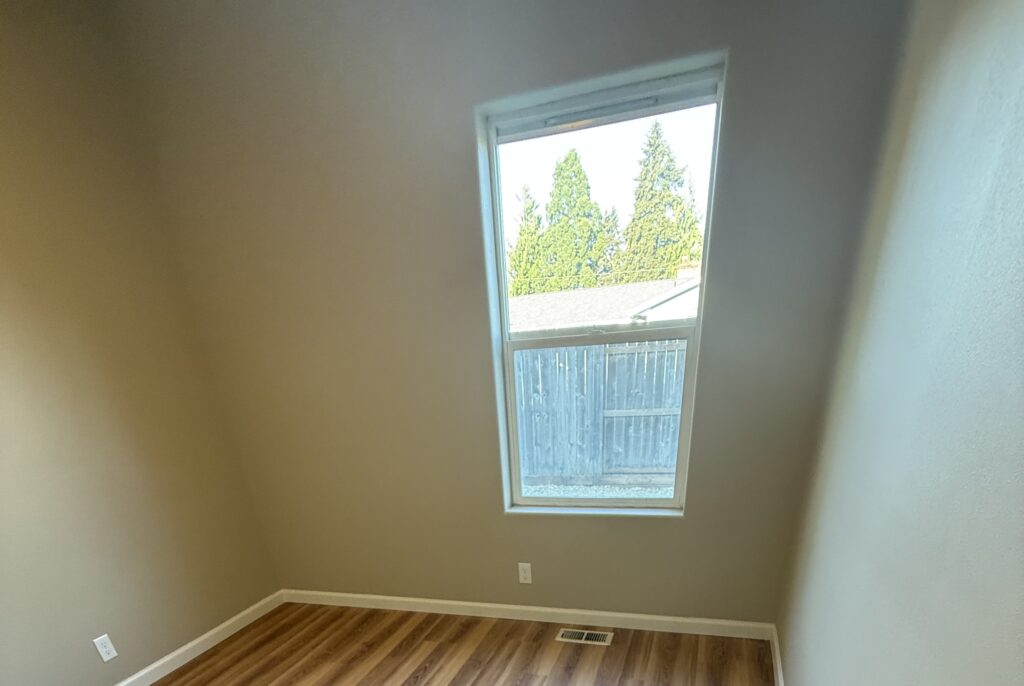 New window installation in Pleasant Hill, Oregon in a remodeled room with finished trim and updated flooring.