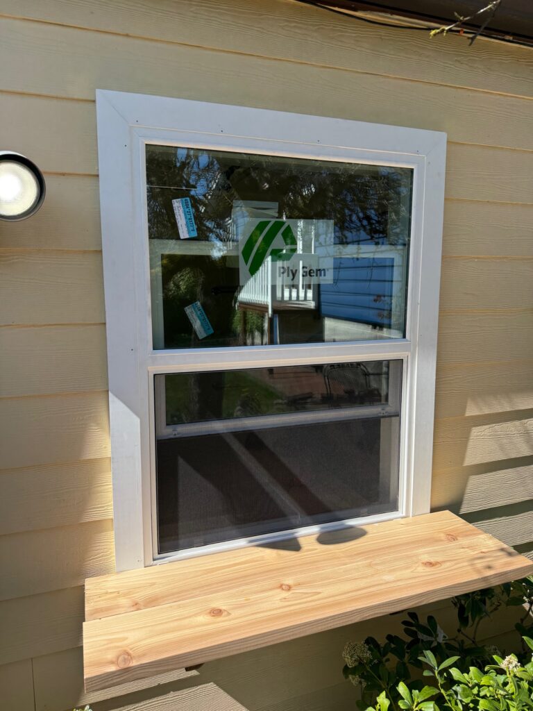 New replacement window installed in Creswell, Oregon with white exterior trim and finished siding.